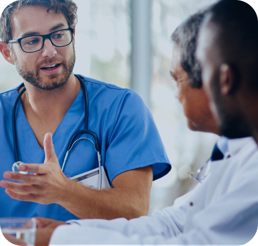 Male HCP in blue scrubs talking to other trusted medical partners.