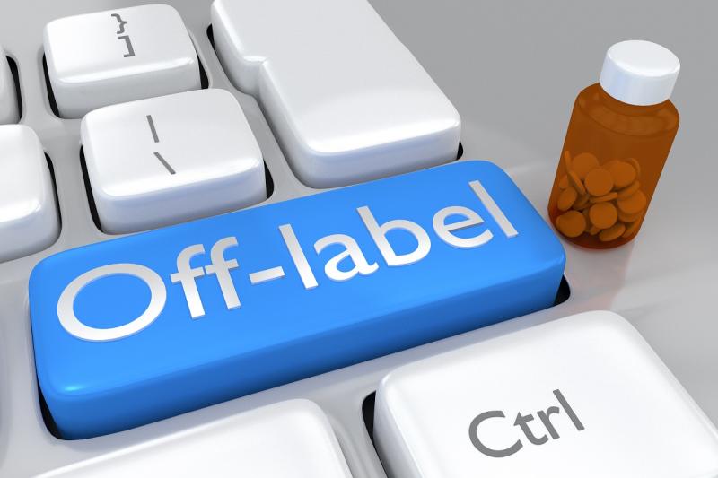 Off-label keyboard button beside a bottle of medicine